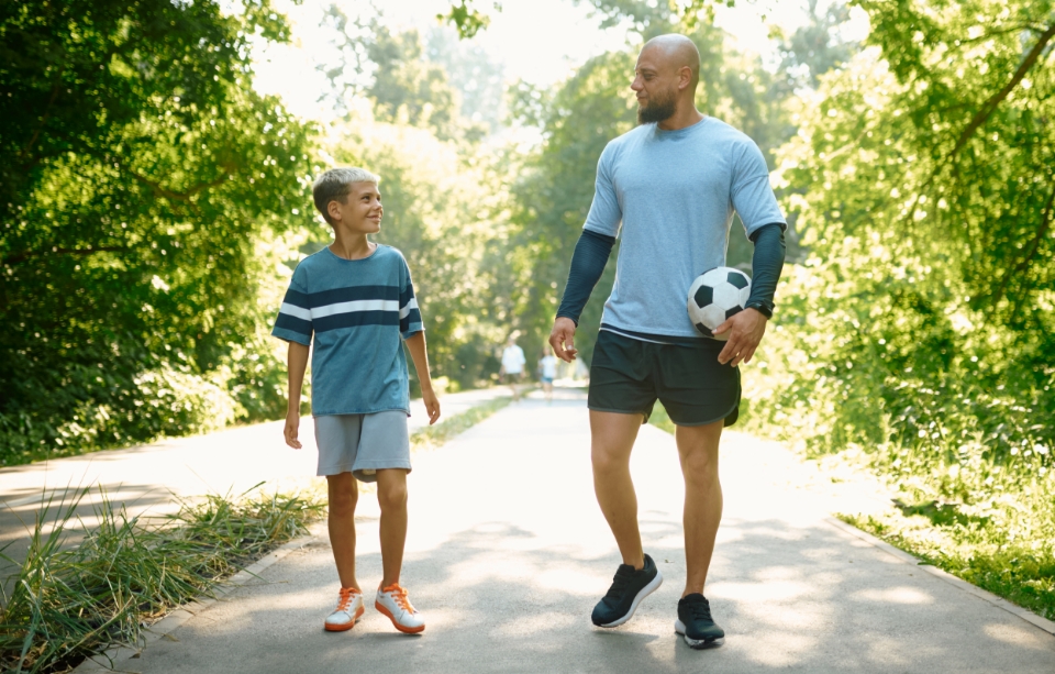 father and son with soccer ball